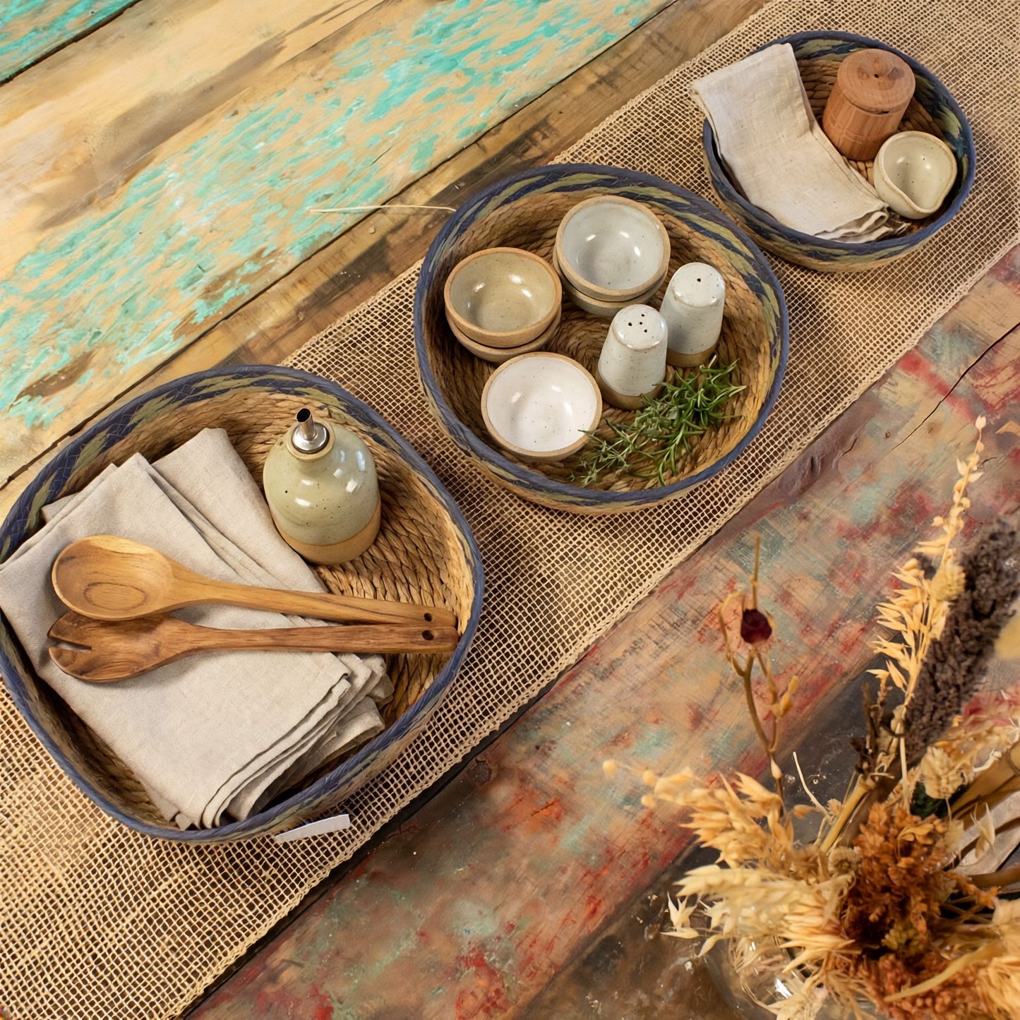 Set of 3 natural straw and seagrass tray baskets with green and blue detailing.