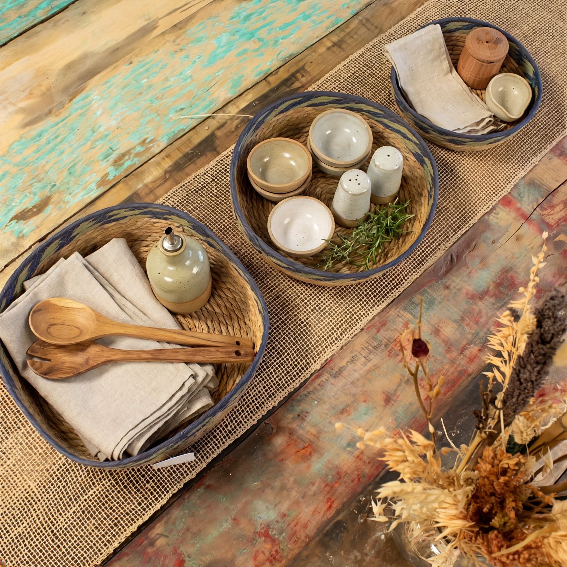 Set of 3 natural straw and seagrass tray baskets with green and blue detailing.
