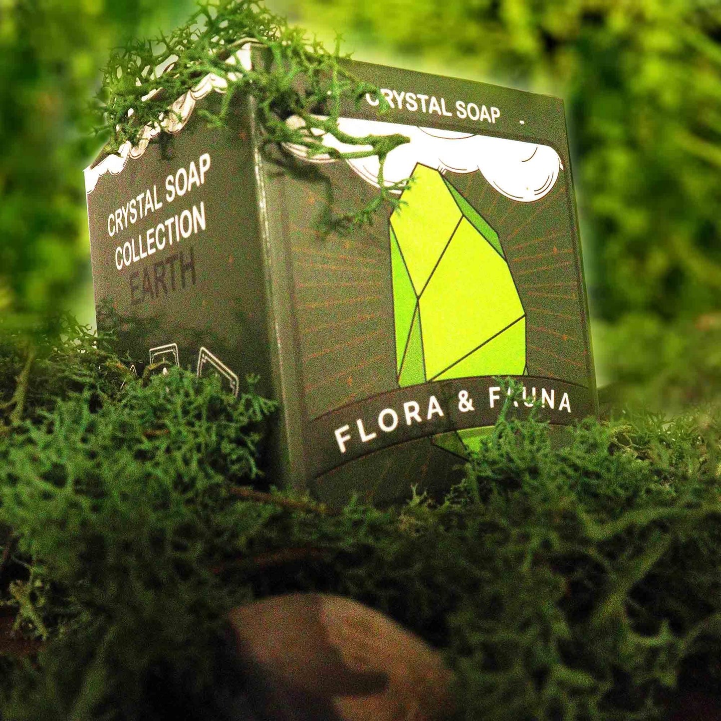 A box of Crystal Elemental Soap - Earth, surrounded by moss.