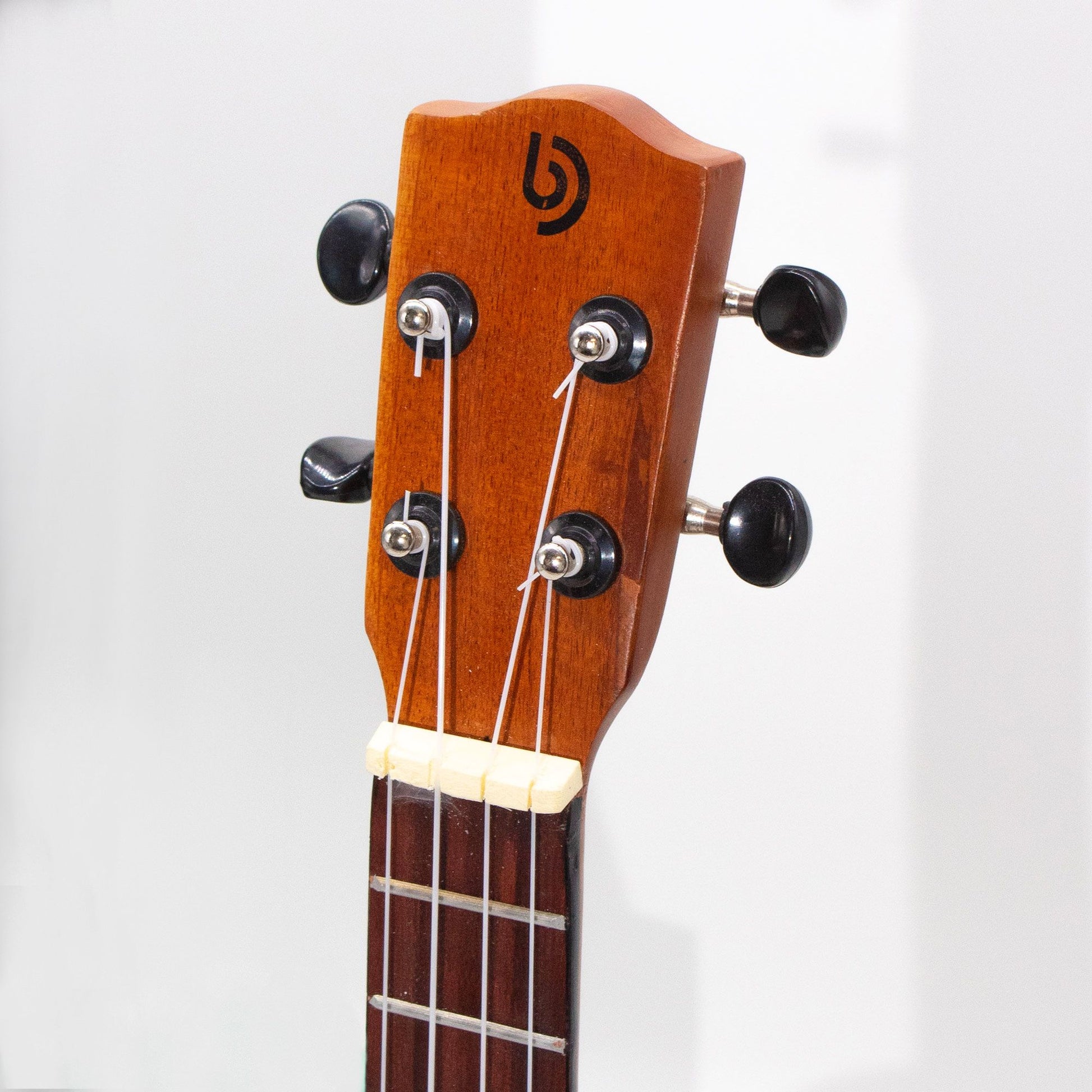 Ukulele headstock with tuning pegs and logo.