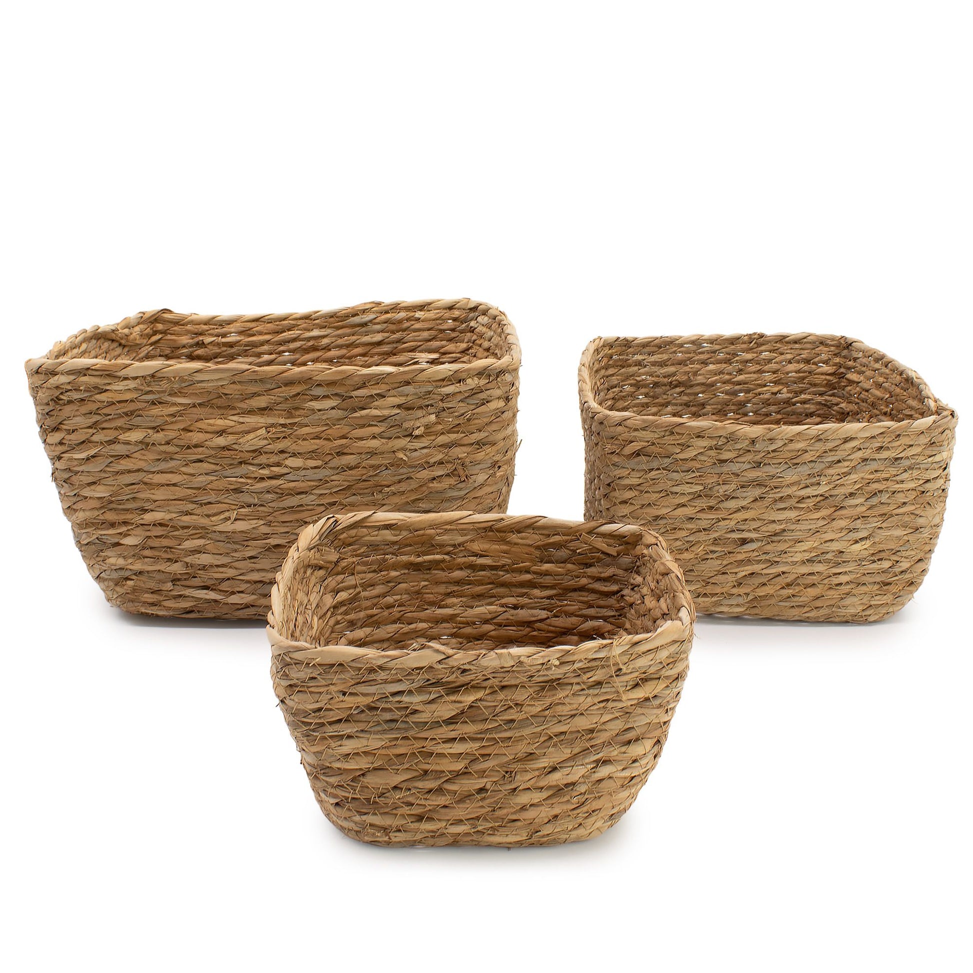 Set of three natural seagrass square baskets in varying sizes.
