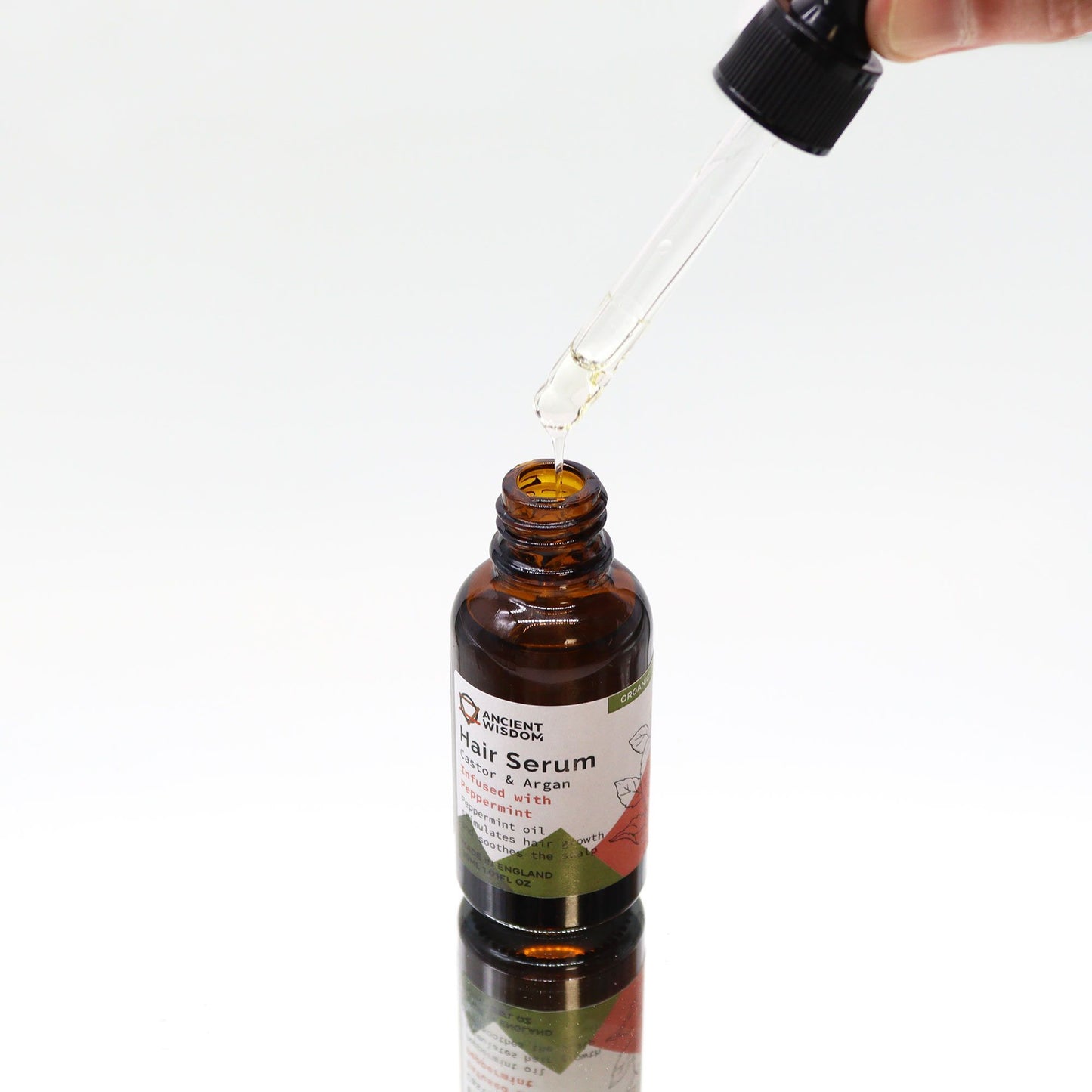 Bio-Pfefferminze Haarserum in Braunglasflasche mit Pipette.