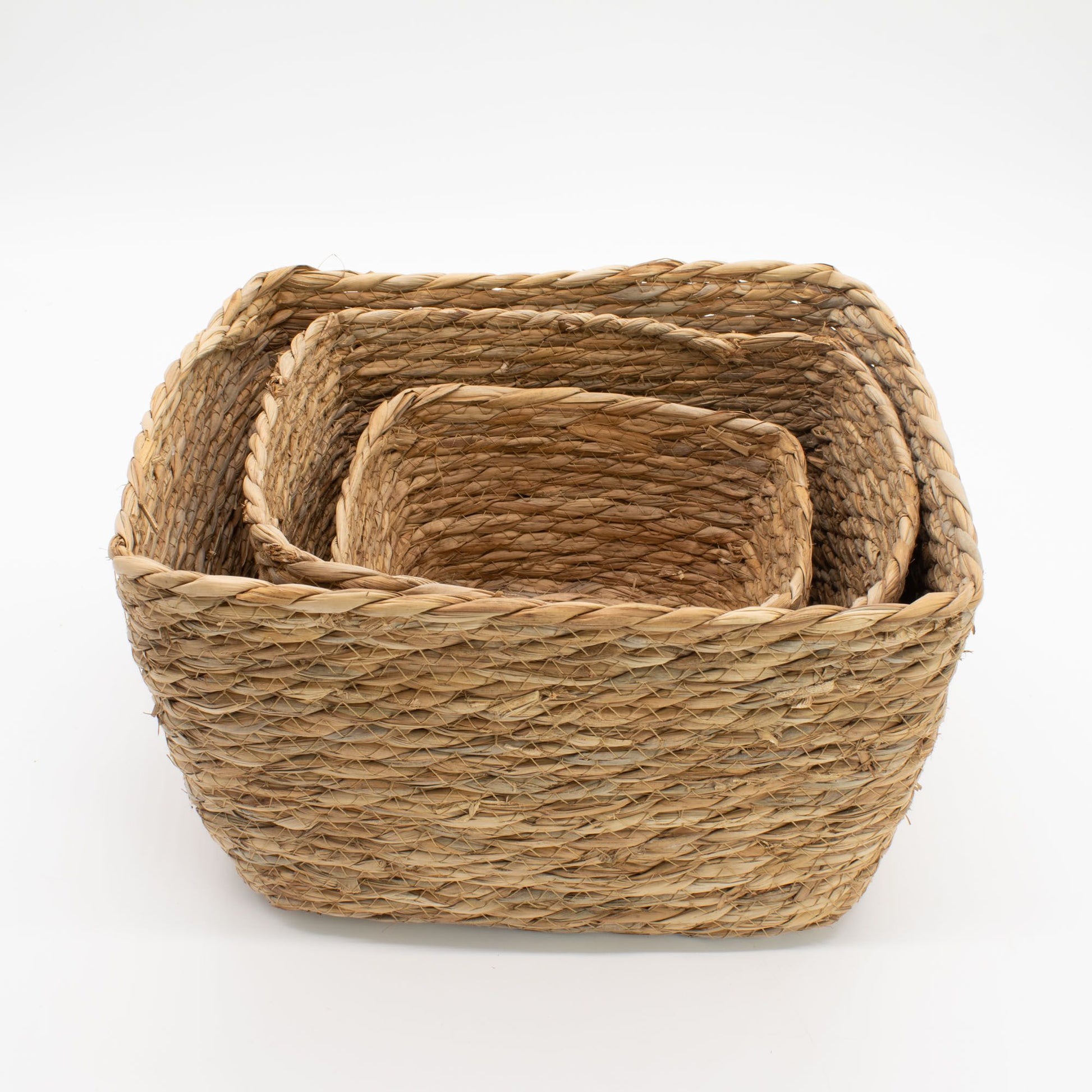 Set of 3 natural seagrass square baskets nested together.