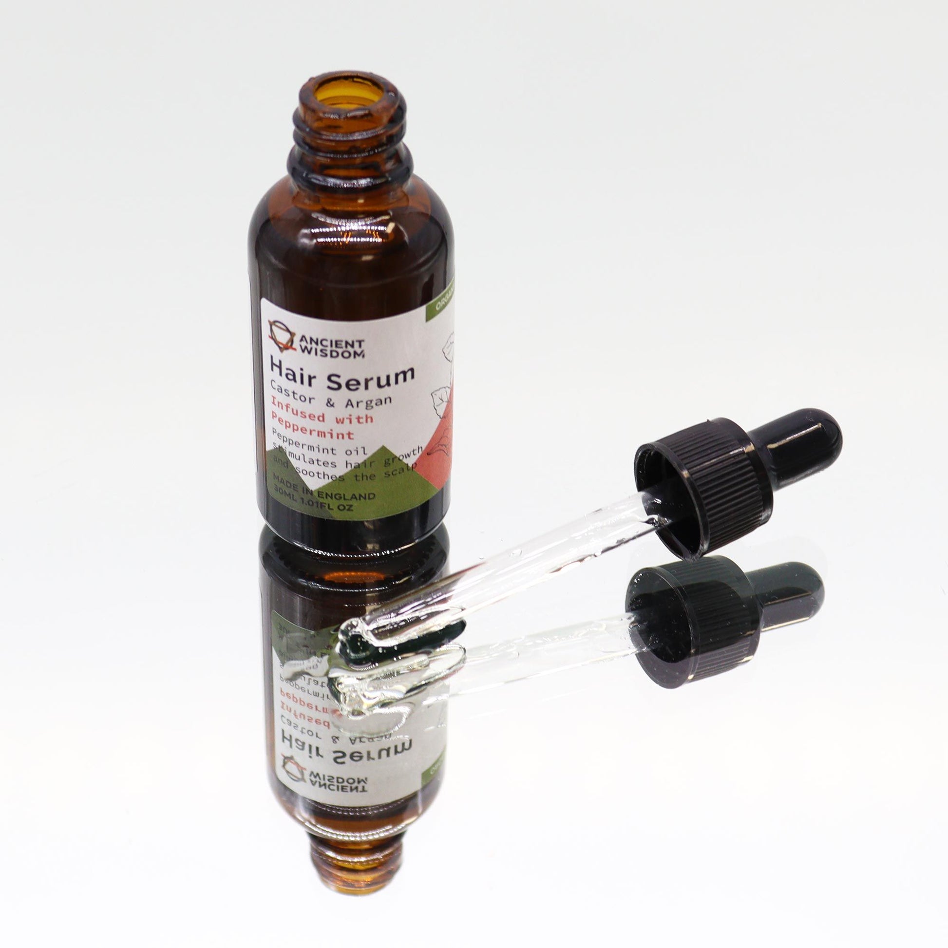 Bio-Pfefferminze Haarserum in Braunglasflasche mit Pipette.