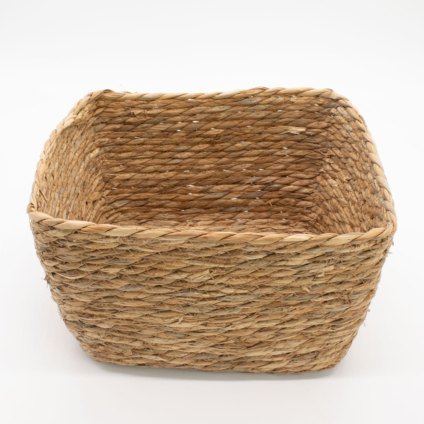 A natural seagrass square basket with woven texture.