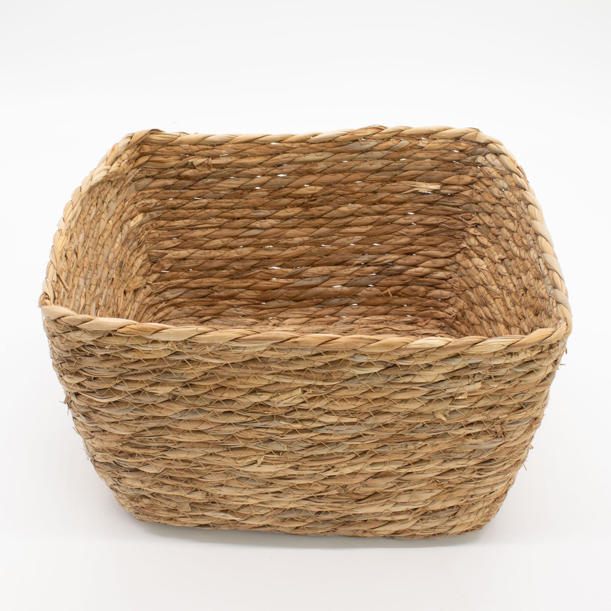 A natural seagrass square basket with woven texture.