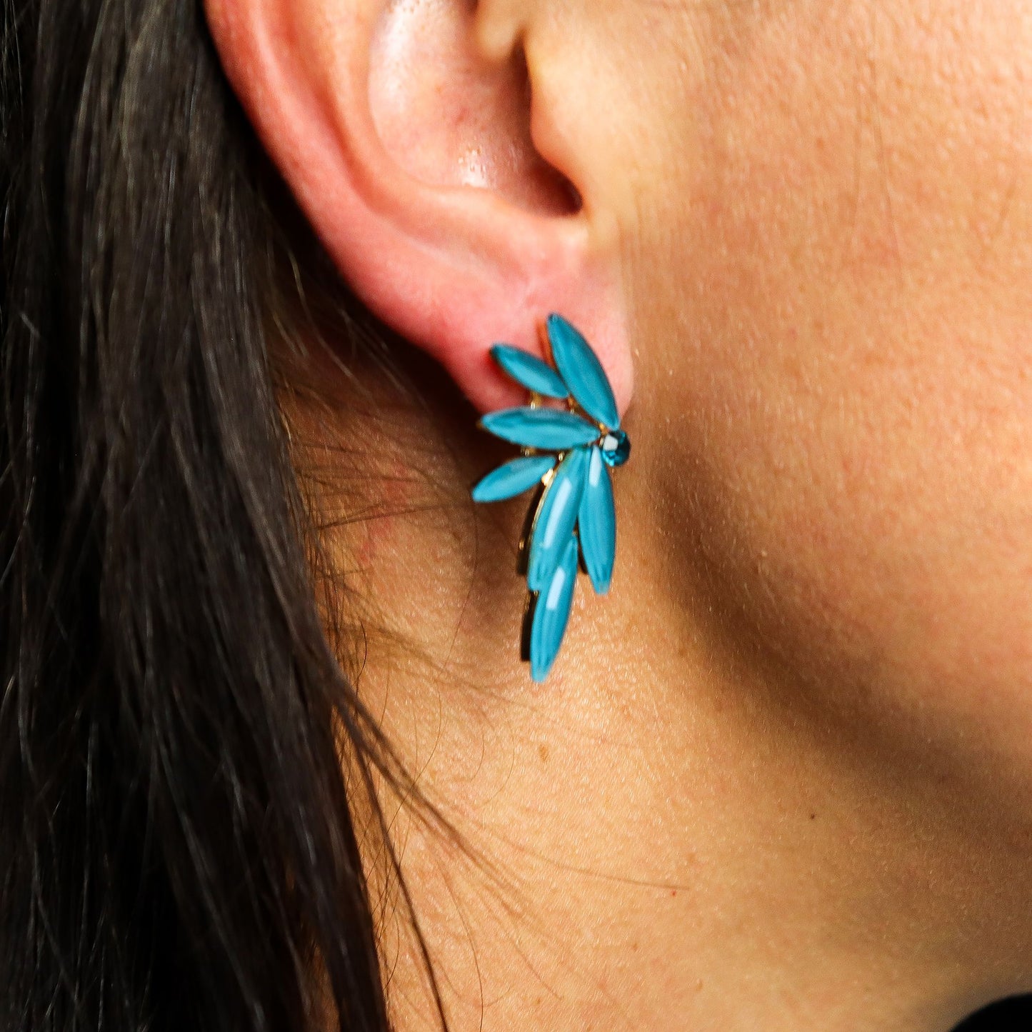Teal green vintage glass earrings with a floral design.
