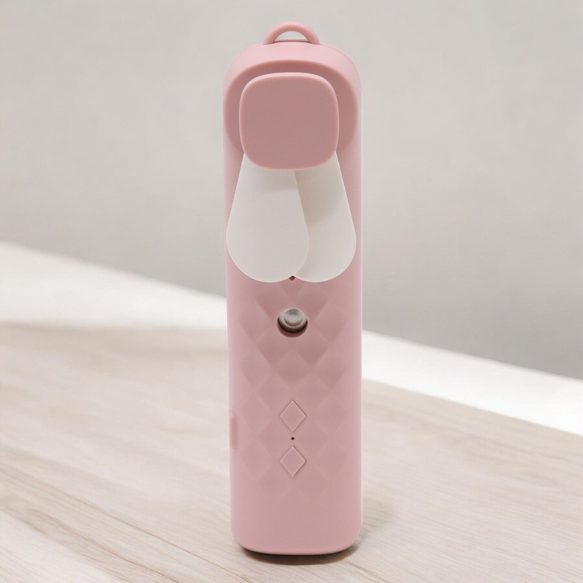 Pink nano mist face fan and spray with bunny ear design.