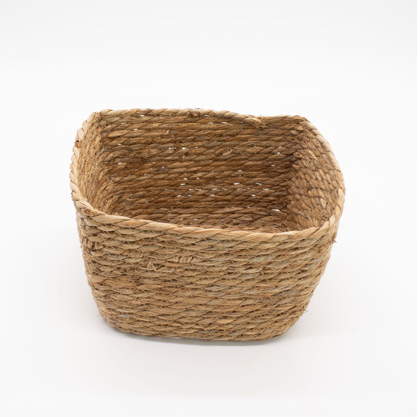 A natural seagrass square basket with a woven texture.