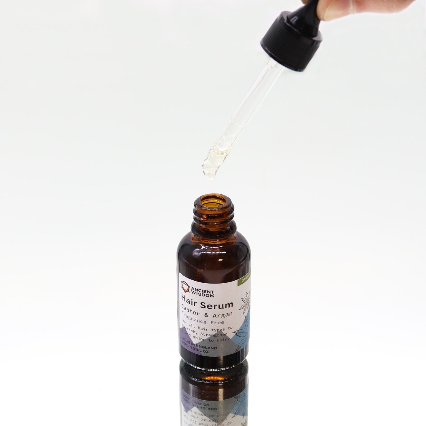 Haarserum aus Rizinus- und Arganöl in einer braunen Glasflasche mit Pipette.