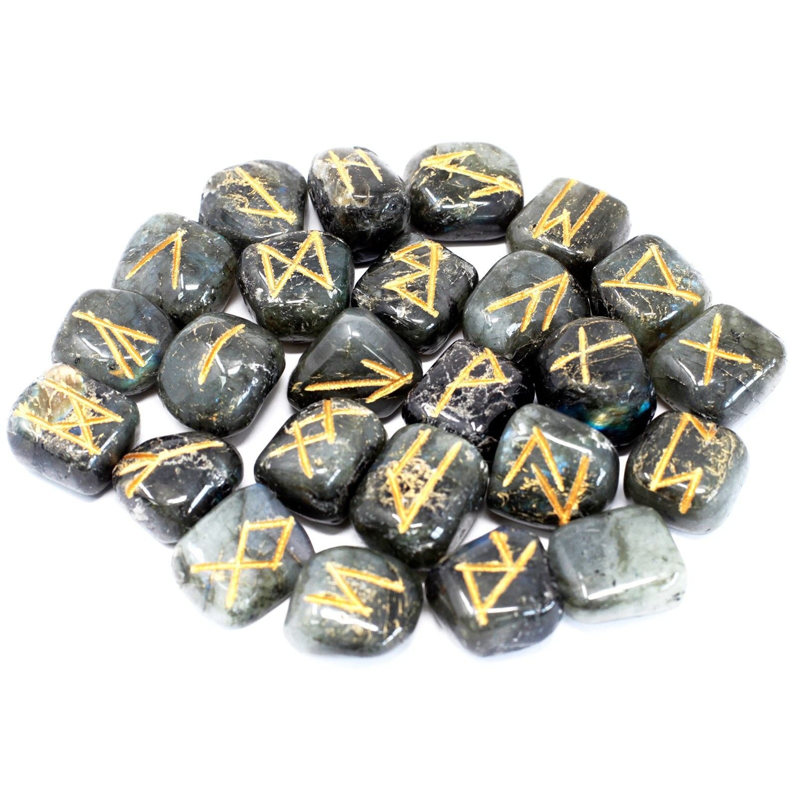 A pile of labradorite rune stones with gold symbols on a white background.