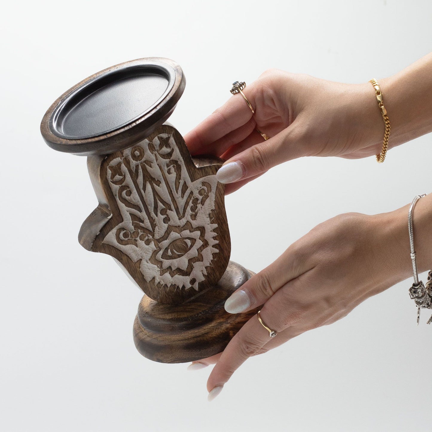 Small mango wood Hamsa hand candle stand with carved details.