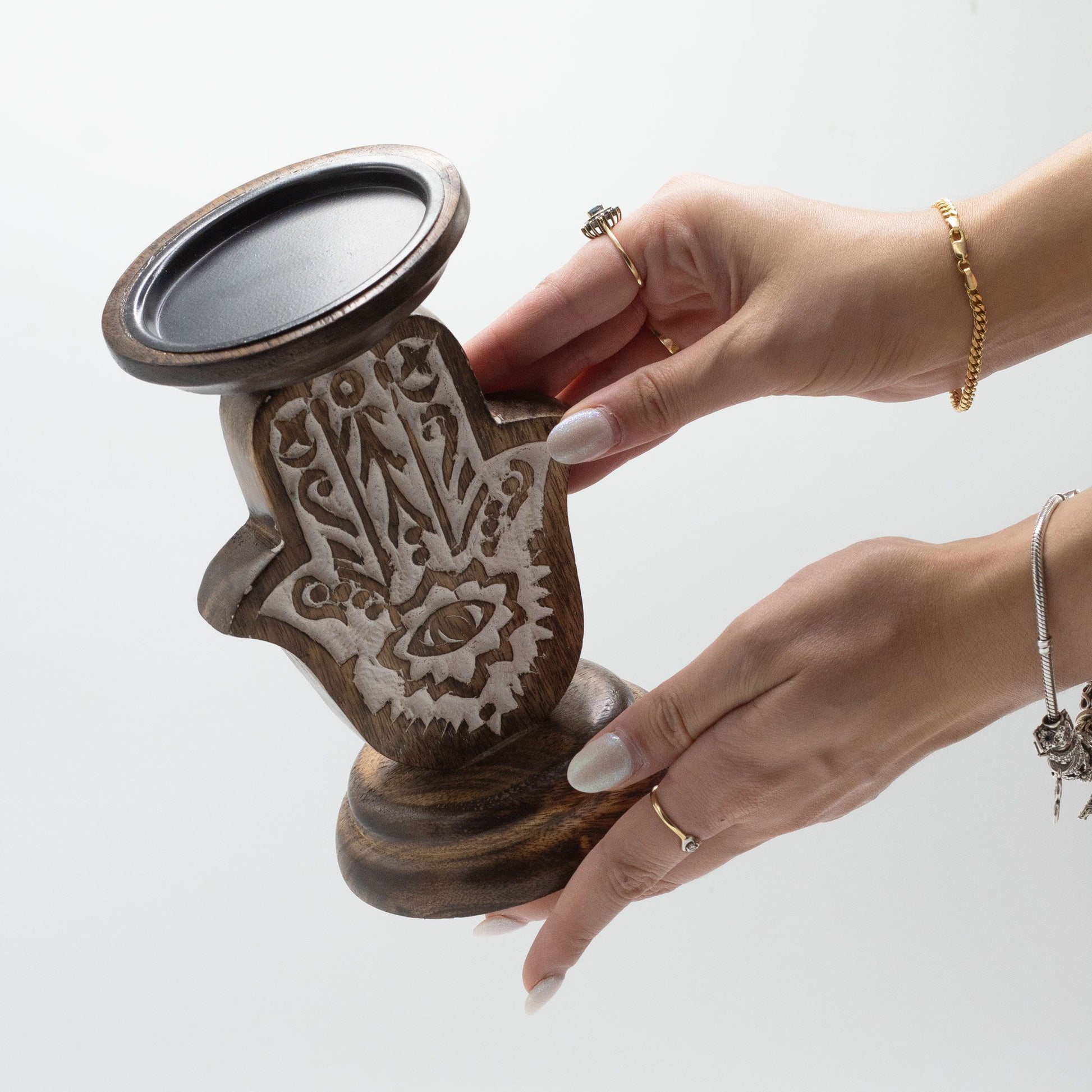 Small mango wood Hamsa hand candle stand with carved details.