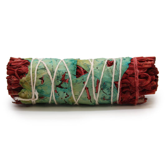 Smudge stick with white sage, dragon's blood, and flowers, bound with string.