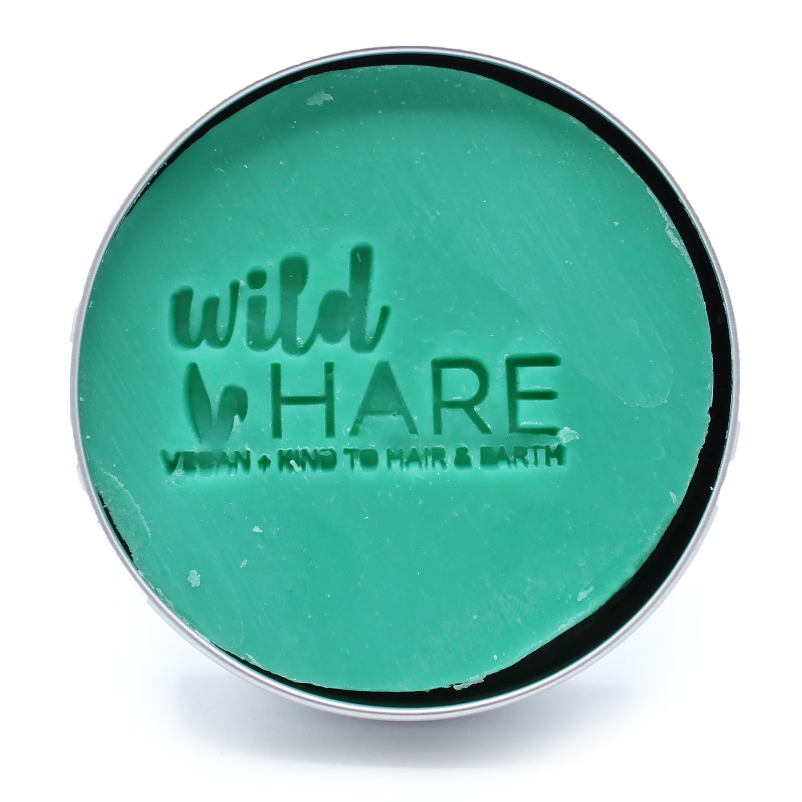 A green solid shampoo bar in a tin with the Wild Hare logo.