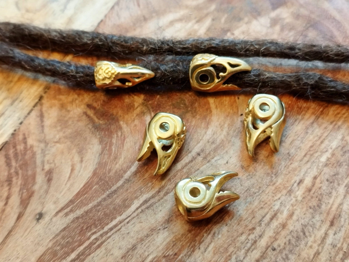 Viking style stainless steel dread beads shaped like bird or raven heads.